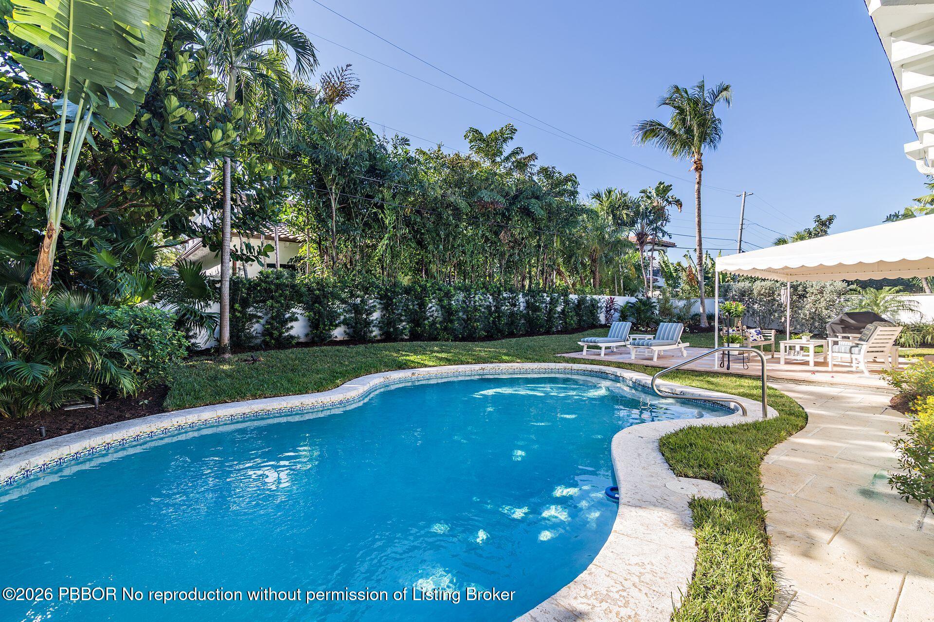 224 Churchill Road West Palm Beach, FL 33405 - Photo 22 of 33 a swimming pool with outdoor seating and yard