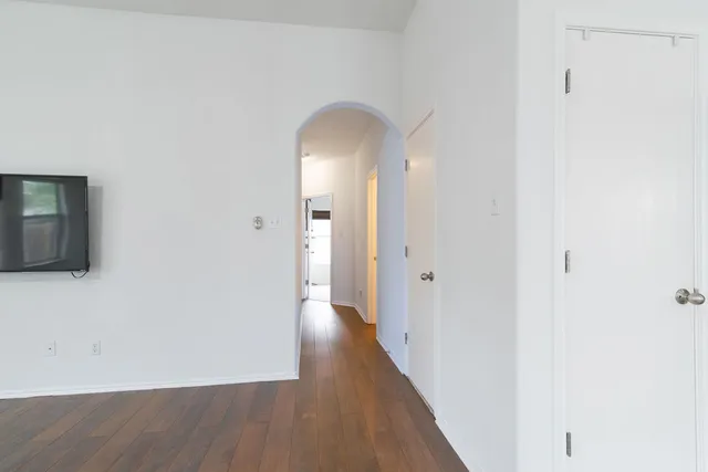 a view of a room with wooden floor