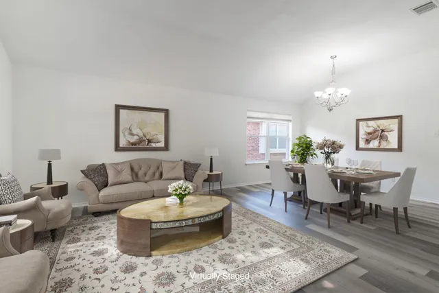 a living room with furniture and a chandelier