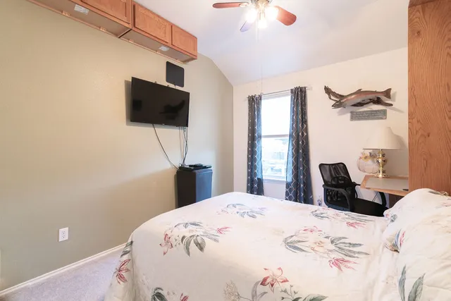 a bedroom with a bed and a flat screen tv