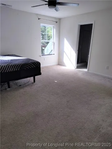 a spacious bedroom with a bed and a window