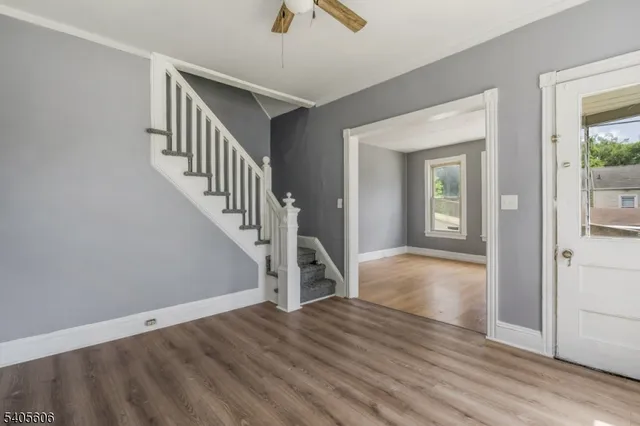 an empty room with fan and windows