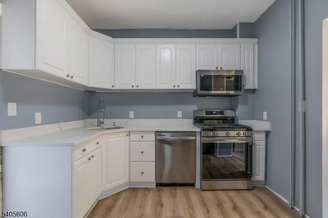 a kitchen with a refrigerator stove and microwave