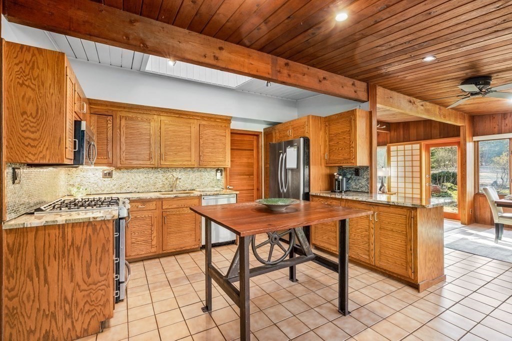 175 Bay Road Sharon, MA 02067 - Photo 9 of 19 a kitchen with stainless steel appliances granite countertop wooden cabinets a dining table and chairs