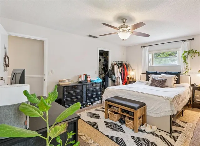 a bed room with a bed and a chandelier