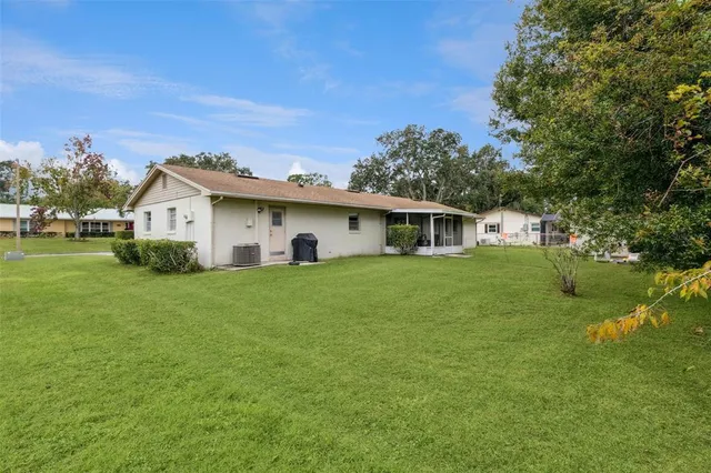 a backyard of a house with table and chairs