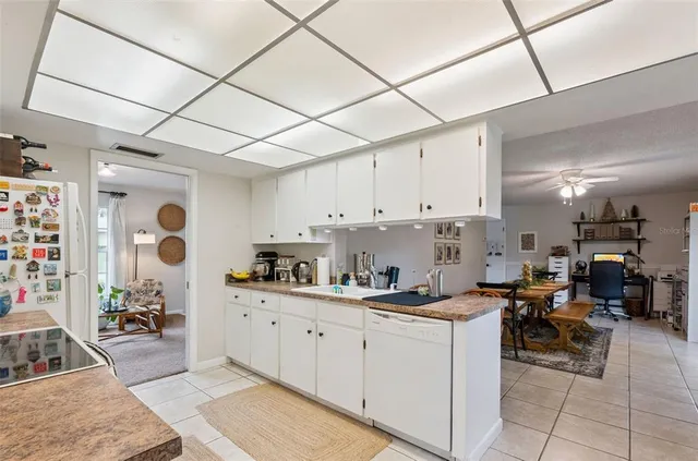 a kitchen with cabinets and window