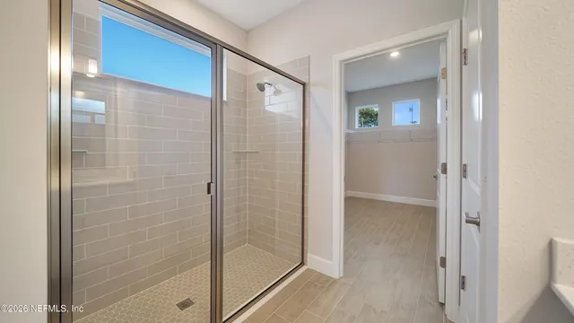 a bathroom with a glass shower door
