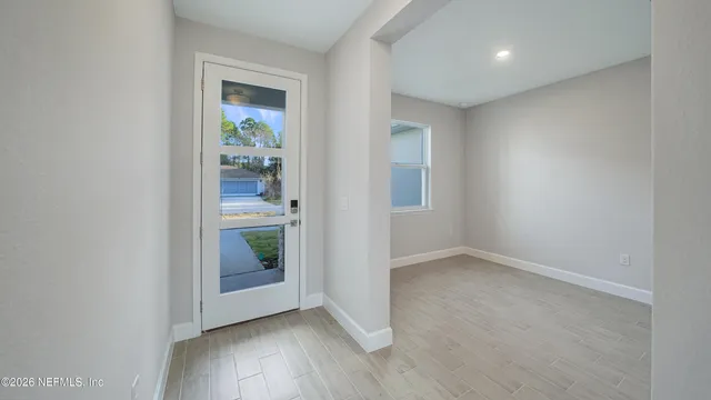 an empty room with mirror and entrance