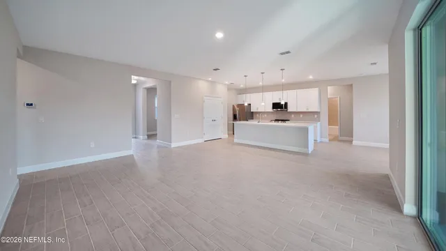 a view of a kitchen with a sink and a refrigerator