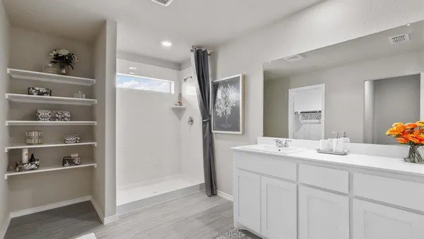 a bathroom with a sink double vanity and shower