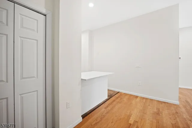 a view of a room with wooden floor