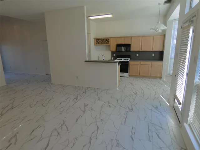 a view of a kitchen with microwave and cabinets