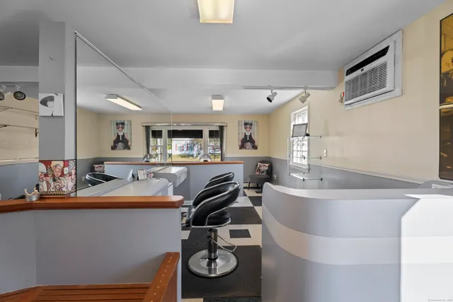 a living room with stainless steel appliances kitchen island granite countertop furniture and a view of kitchen