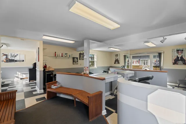 a room with furniture a flat screen tv and a table