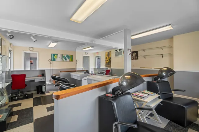 a living room with furniture a flat screen tv and a table