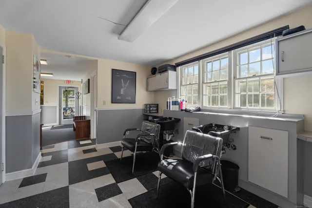 a view of hallway with stairs and wooden floor