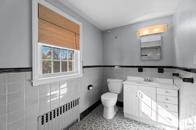 a bathroom with a tub shower and sink