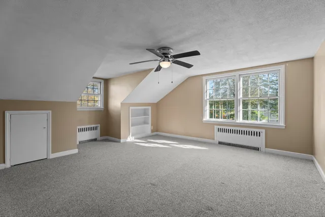 a view of livingroom and chandelier fan