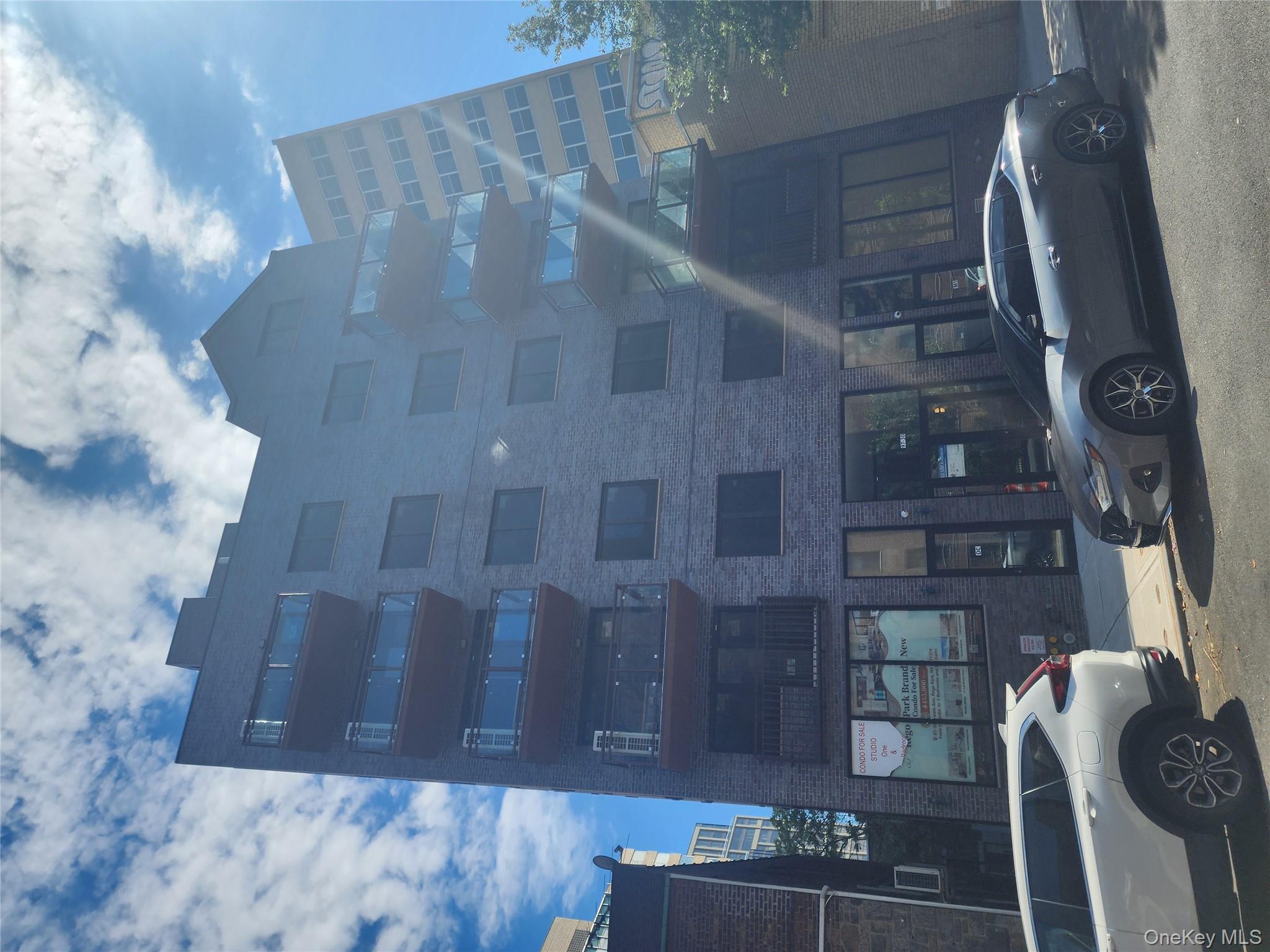 97-30 64th Avenue, Unit 4A Queens, NY 11374 - Photo 1 of 6 a view of a brick building with many windows