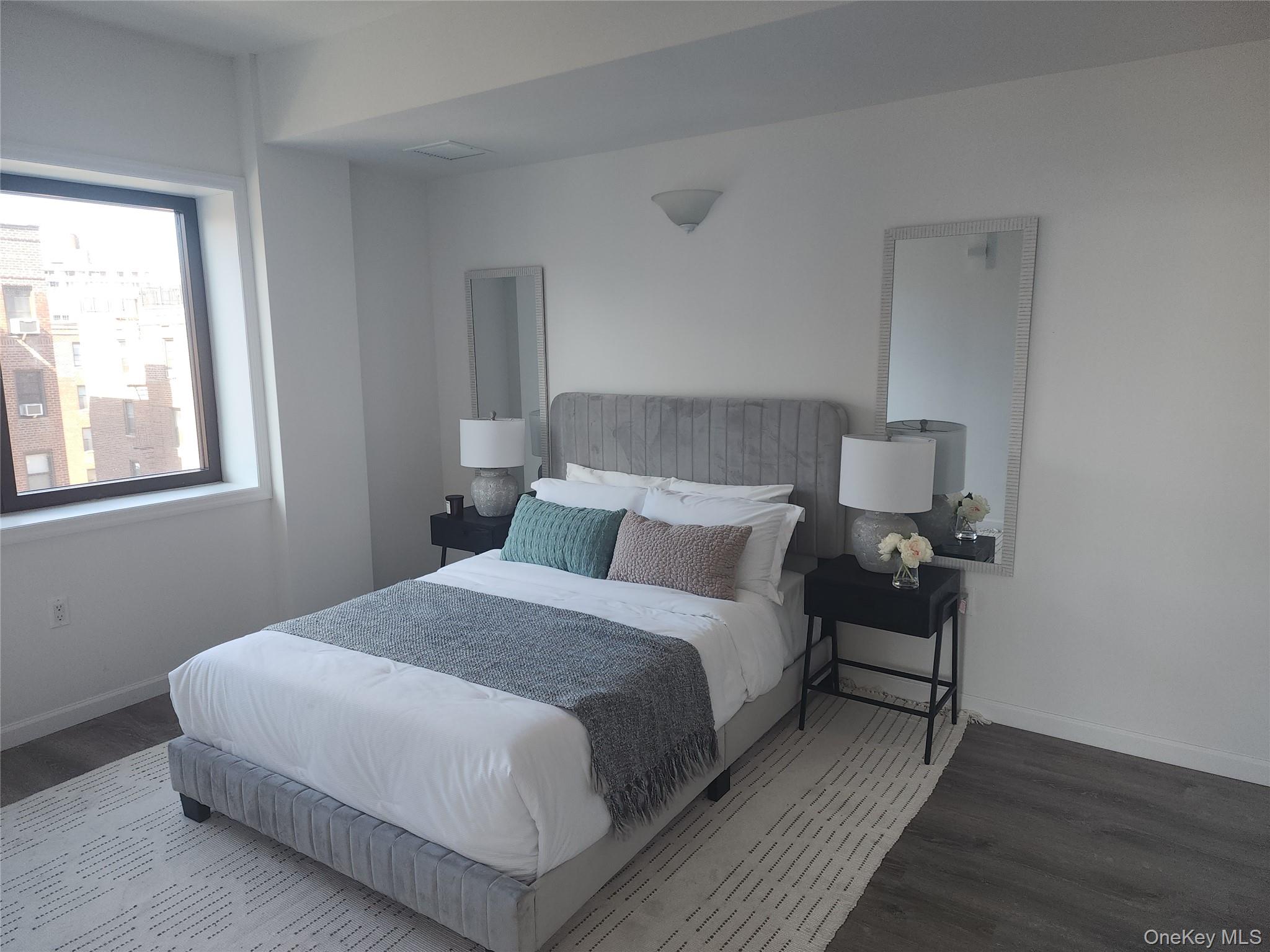 97-30 64th Avenue, Unit 4A Queens, NY 11374 - Photo 4 of 6 a bedroom with a bed and a window