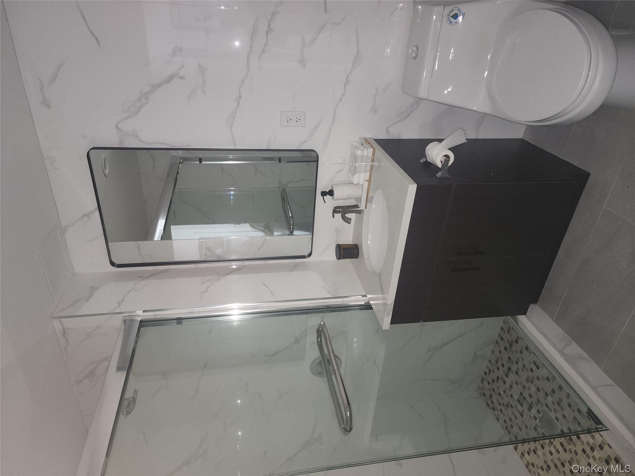 97-30 64th Avenue, Unit 4A Queens, NY 11374 - Photo 5 of 6 a bathroom with a sink a toilet and shower