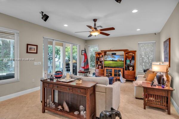 17794 Southwest 47th Street Miramar, FL 33029 - Photo 18 of 39 a living room with furniture a window and a flat screen tv