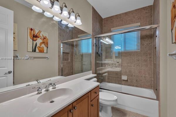 17794 Southwest 47th Street Miramar, FL 33029 - Photo 22 of 39 a bathroom with a sink a toilet a mirror a vanity and shower