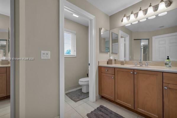 17794 Southwest 47th Street Miramar, FL 33029 - Photo 27 of 39 a bathroom with a double vanity sink and a mirror