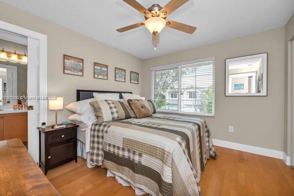 17794 Southwest 47th Street Miramar, FL 33029 - Photo 30 of 39 a bed room with a bed and a chandelier