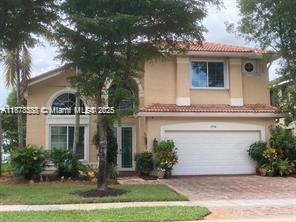 17794 Southwest 47th Street Miramar, FL 33029 - Photo 7 of 39 a front view of a house with a yard and garage