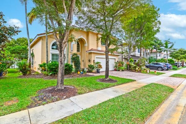 17794 Southwest 47th Street Miramar, FL 33029 - Photo 8 of 39 a front view of a house with garden