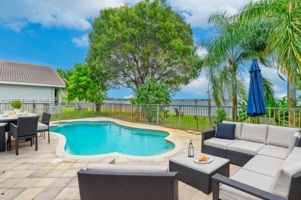 17794 Southwest 47th Street Miramar, FL 33029 - Photo 9 of 39 a view of a patio with swimming pool and furniture