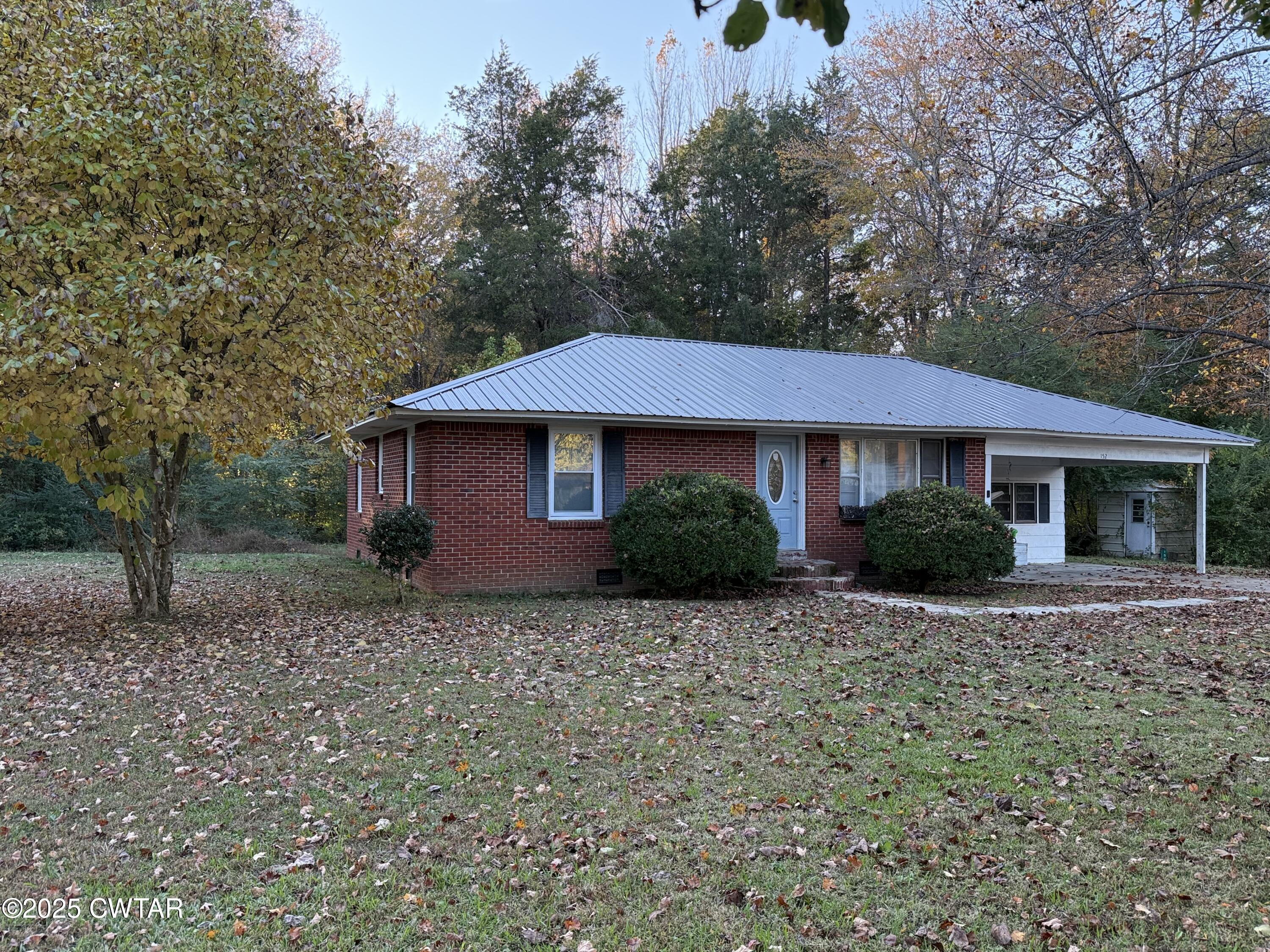 152 Seavers Road Jackson, TN 38301 - Photo 11 of 11 a front view of a house with a garden
