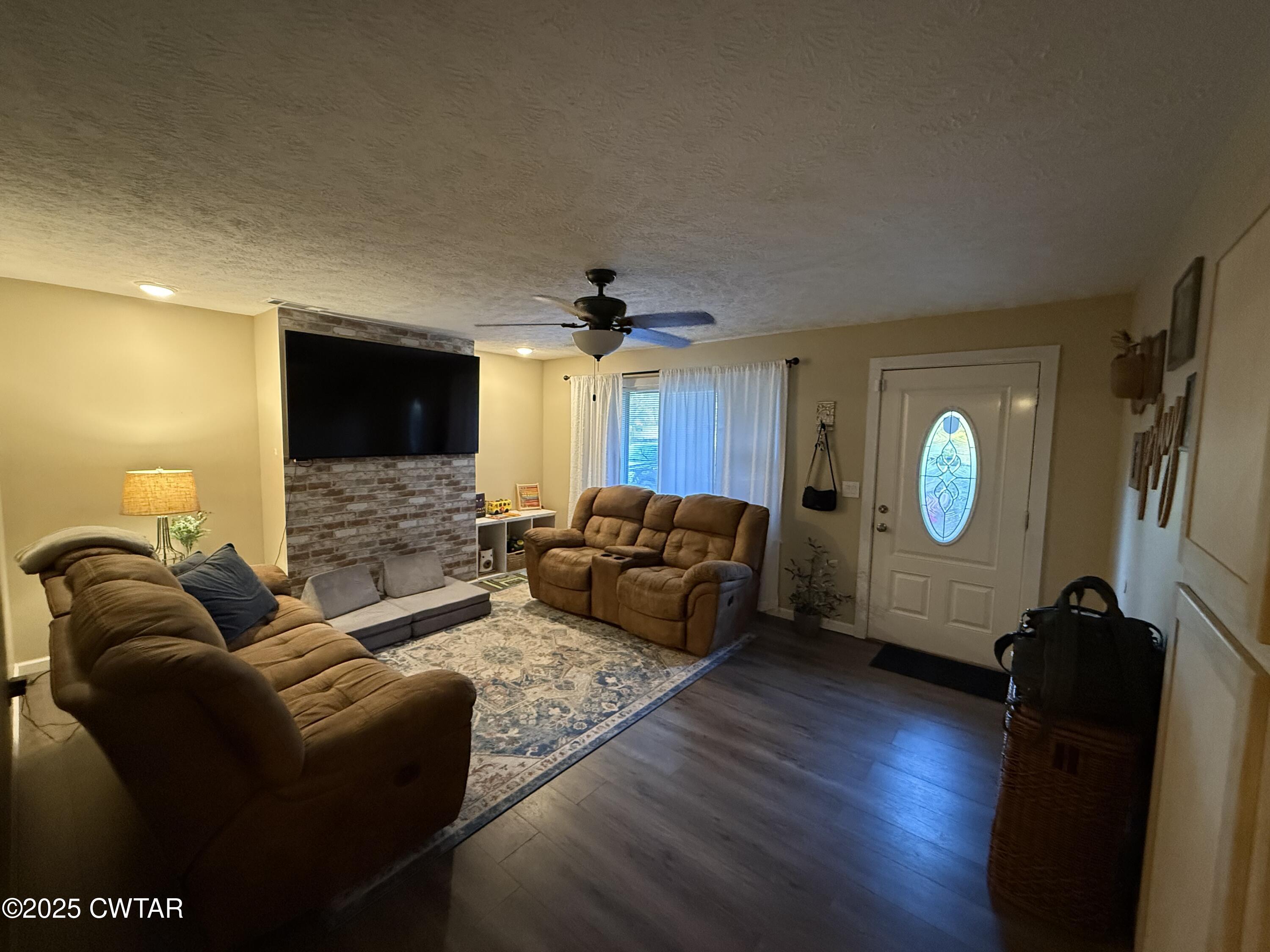 152 Seavers Road Jackson, TN 38301 - Photo 2 of 11 a living room with furniture a ceiling fan and a wooden floor