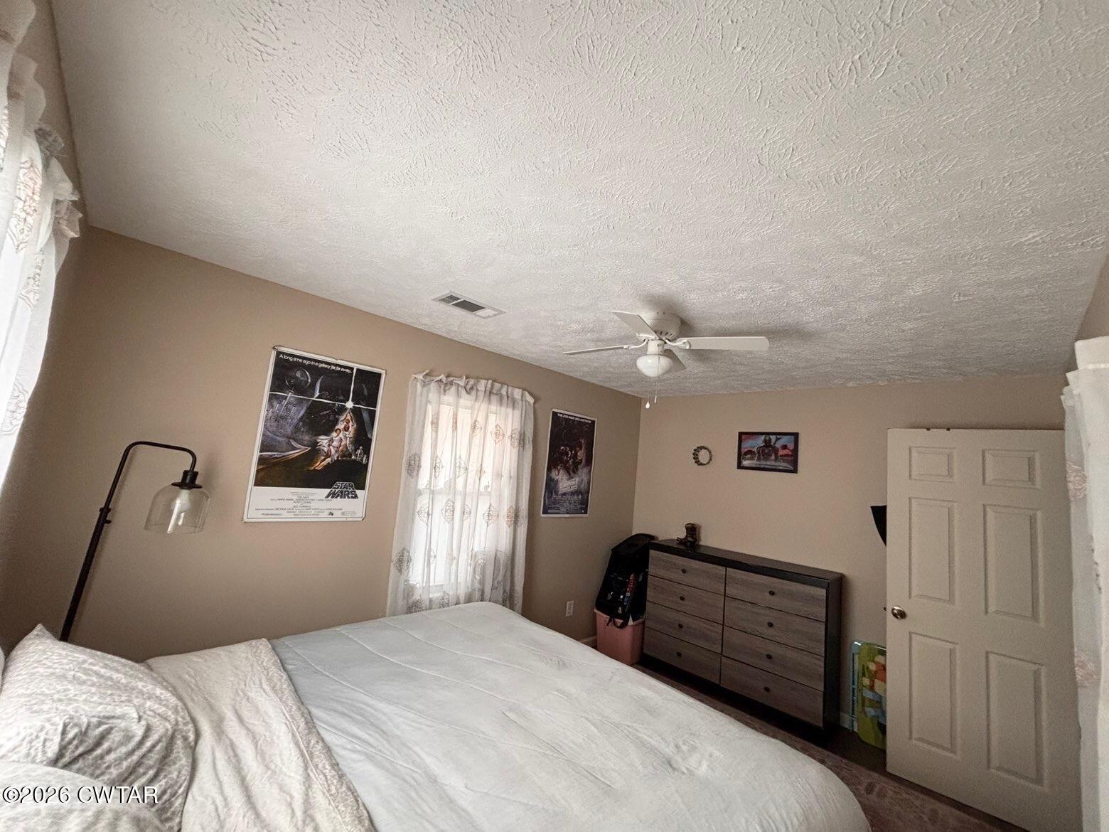 152 Seavers Road Jackson, TN 38301 - Photo 8 of 11 a bedroom with a bed and a chandelier