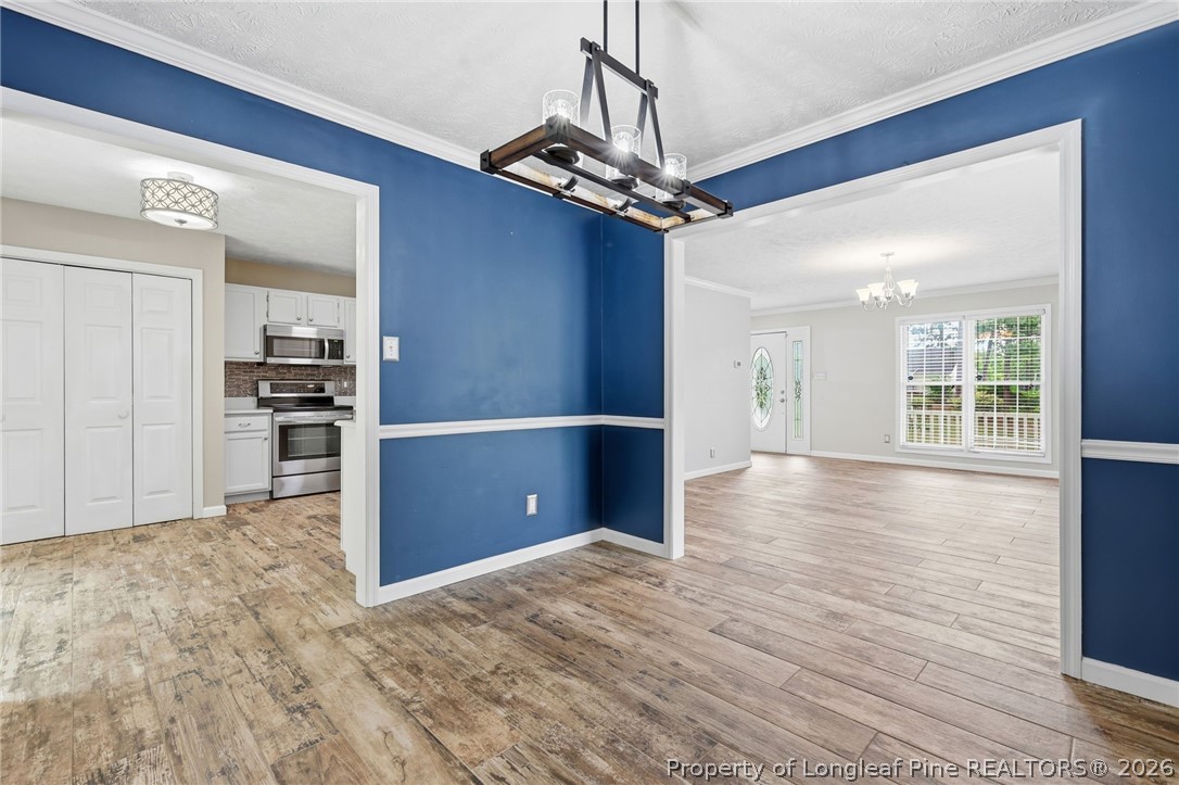 5113 Archer Road Hope Mills, NC 28348 - Photo 15 of 41 a view of a kitchen with wooden floor and a refrigerator