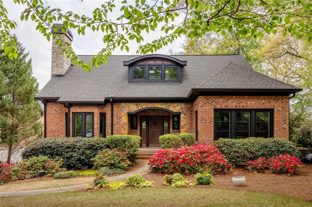 a front view of a house with a garden