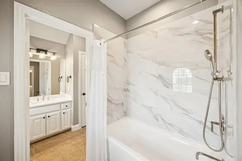 a bathroom with a sink a mirror and a window