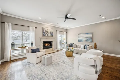 a bedroom with a large bed and wooden floor