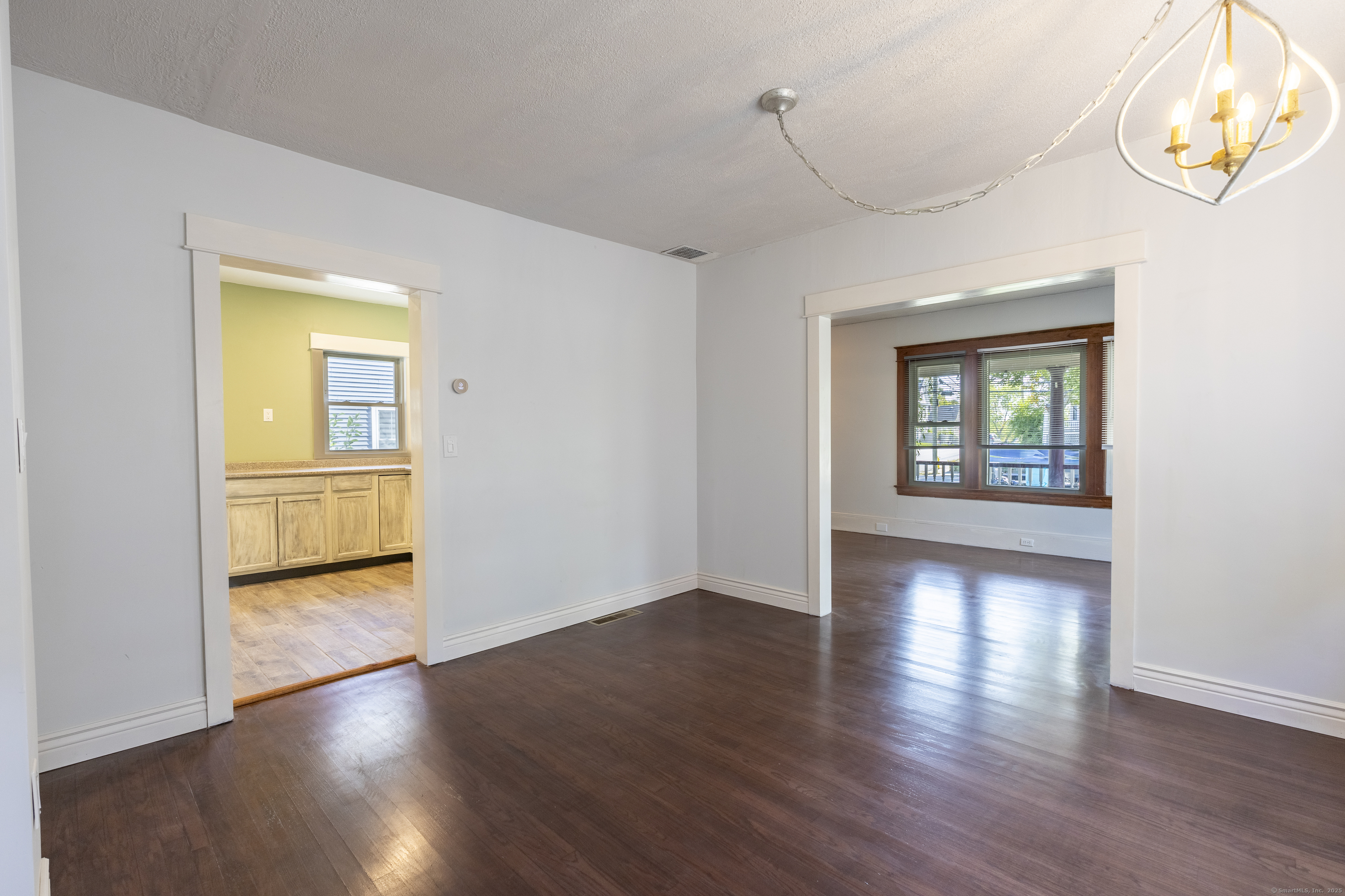 132 Grove Street Putnam, CT 06260 - Photo 11 of 36 an empty room with wooden floor and windows