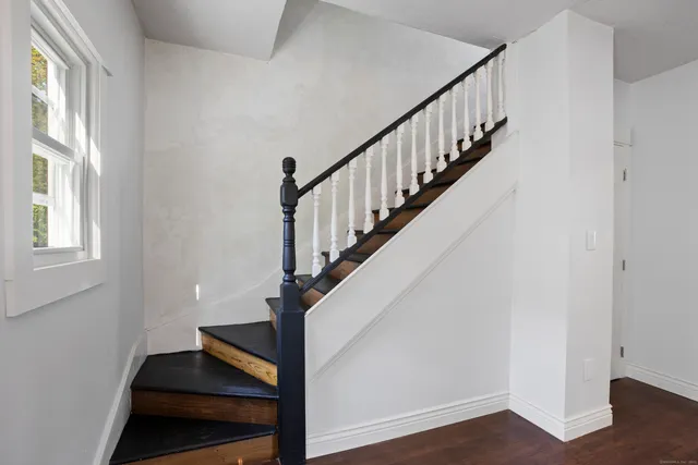 a view of entryway with wooden floor and stairs