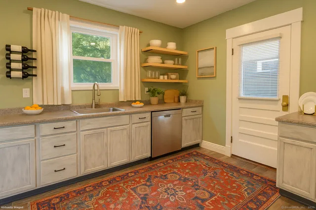 a spacious bathroom with a sink mirror and a window