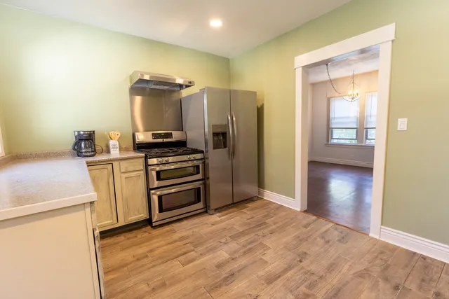a kitchen with a refrigerator and a stove