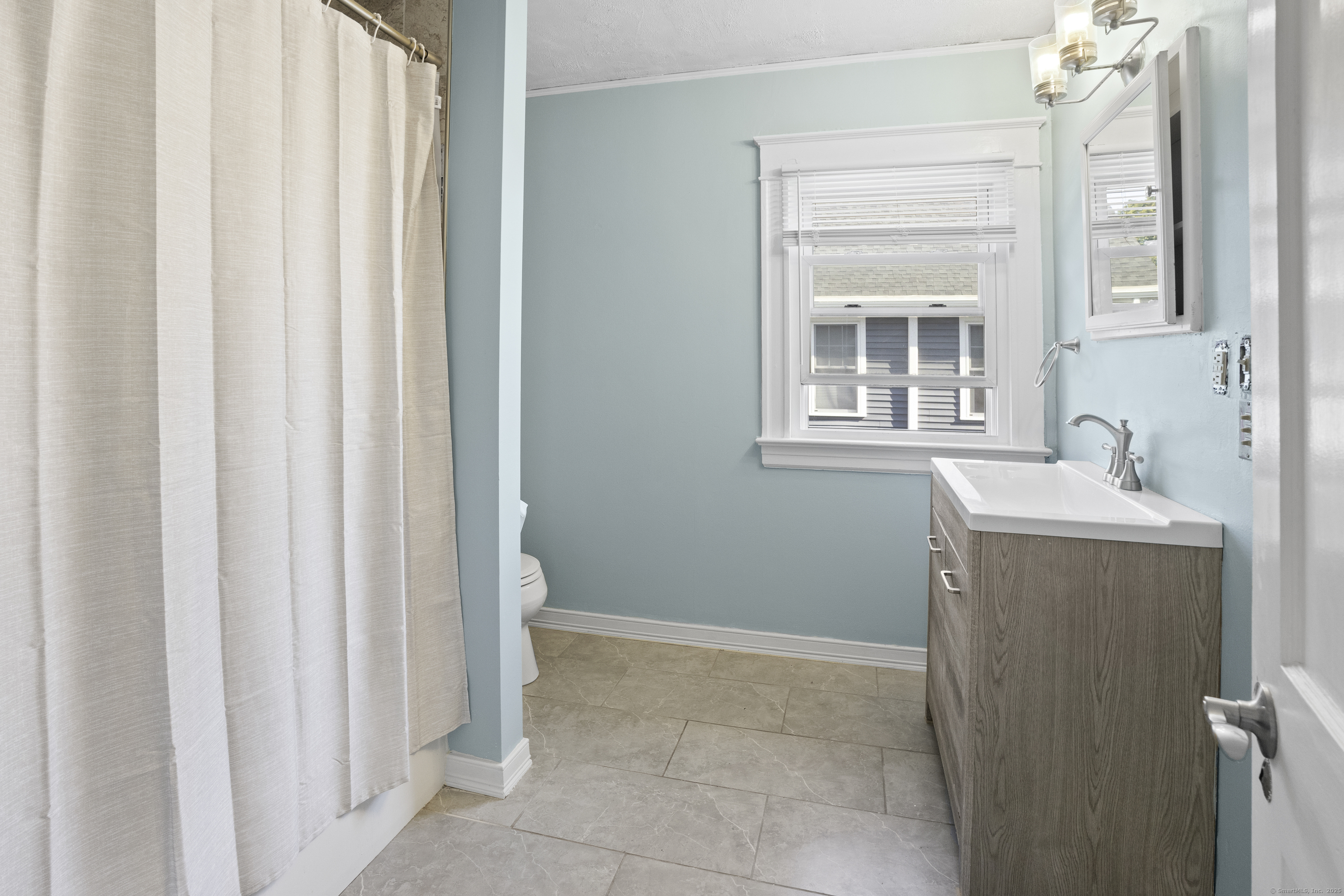 132 Grove Street Putnam, CT 06260 - Photo 24 of 36 a bathroom with a sink and a mirror