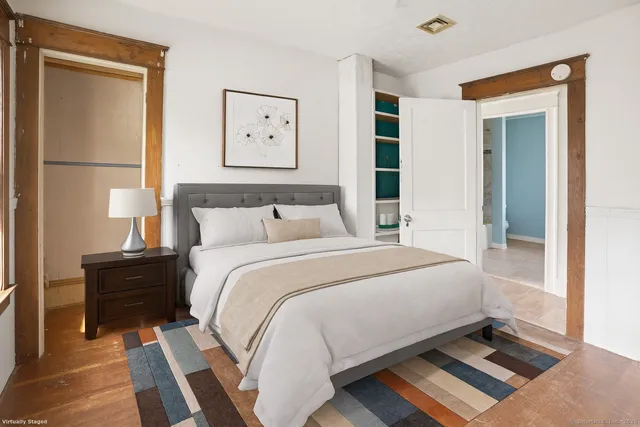 a bedroom with a bed and a window