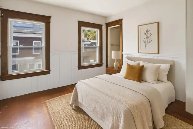 a bedroom with a bed and a window