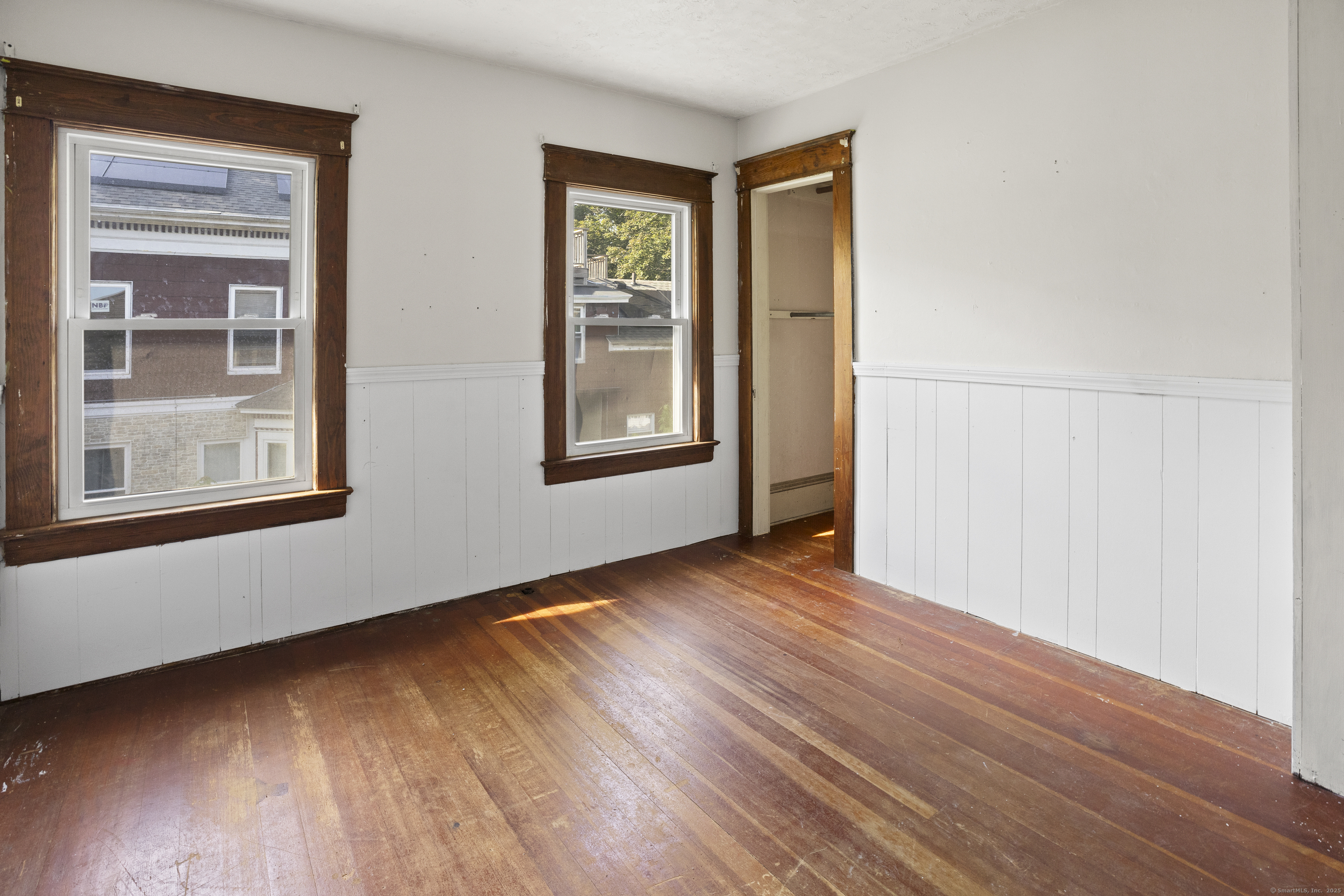 132 Grove Street Putnam, CT 06260 - Photo 30 of 36 a view of an empty room with wooden floor and a window