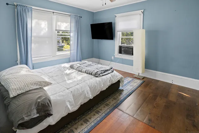 a bedroom with a bed and a window