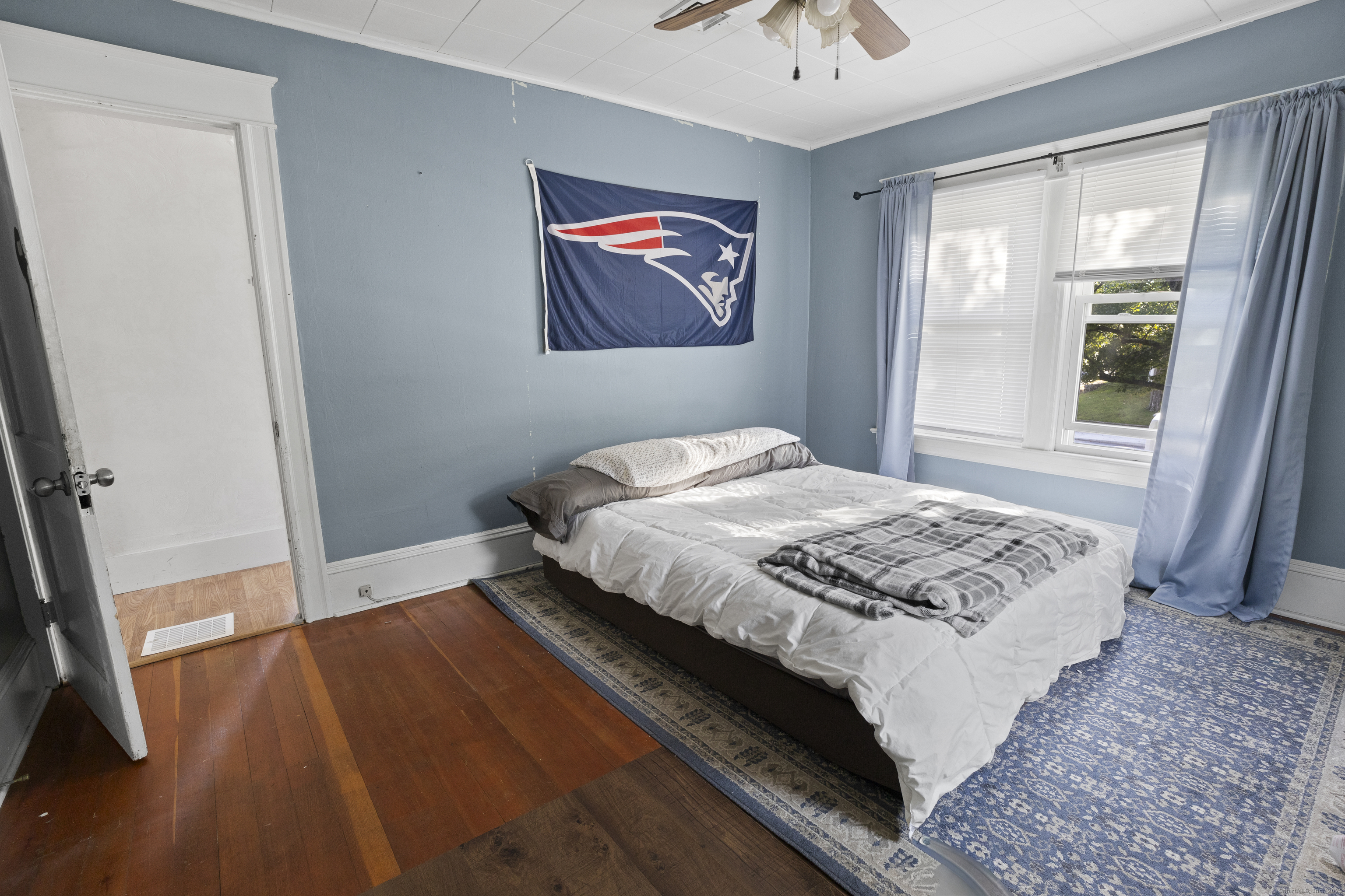 132 Grove Street Putnam, CT 06260 - Photo 32 of 36 a bedroom with a bed and a painting on the wall